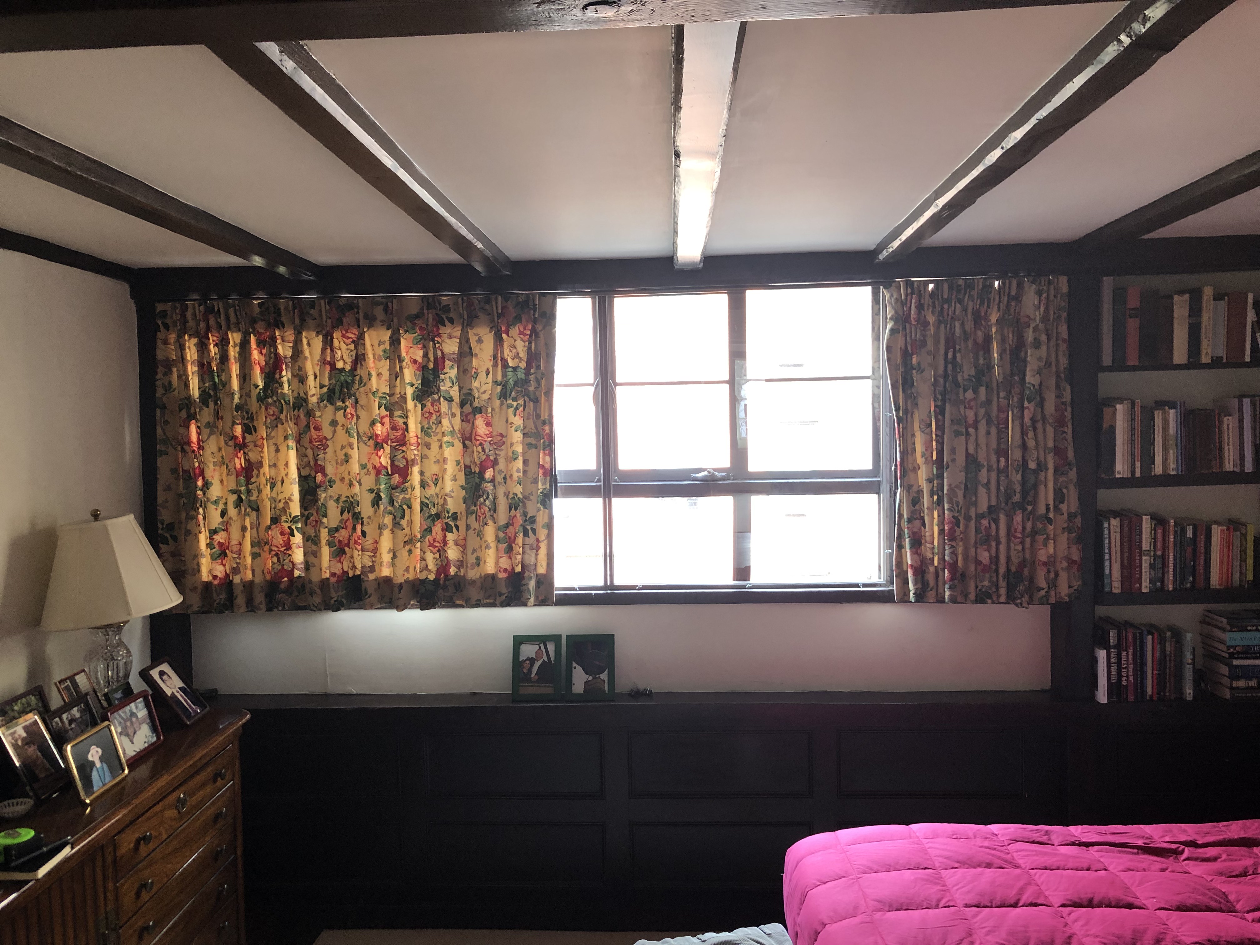 Custom floral drapes installed in bedroom