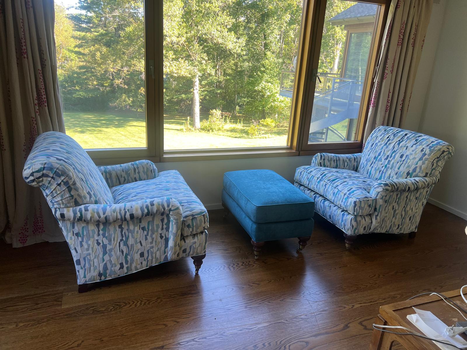 Blue patterned chairs and teal ottoman