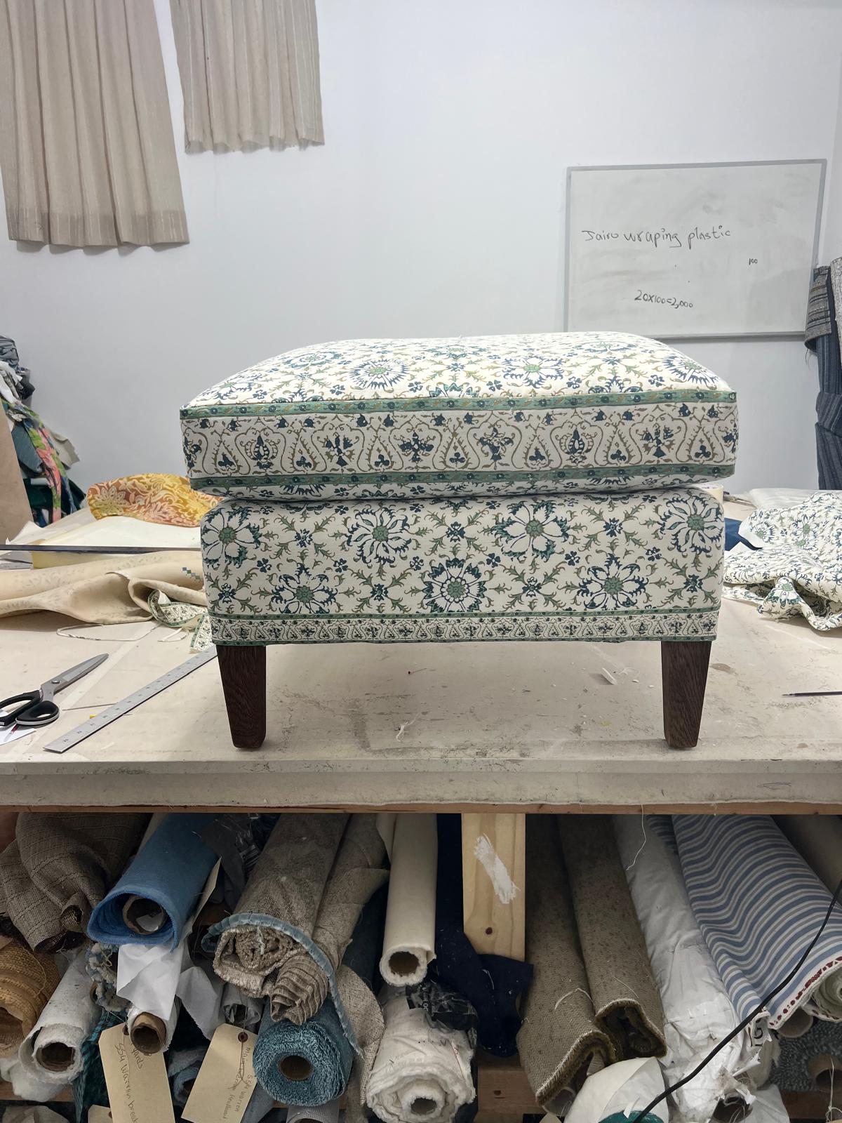 Floral upholstered ottoman