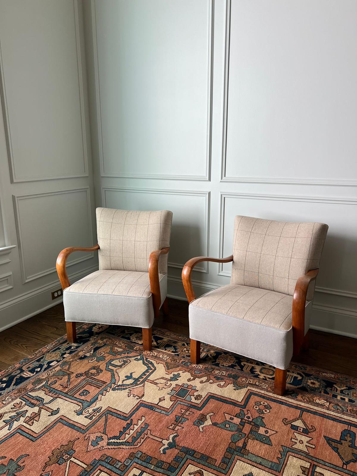 Pair of armchairs in paneled room