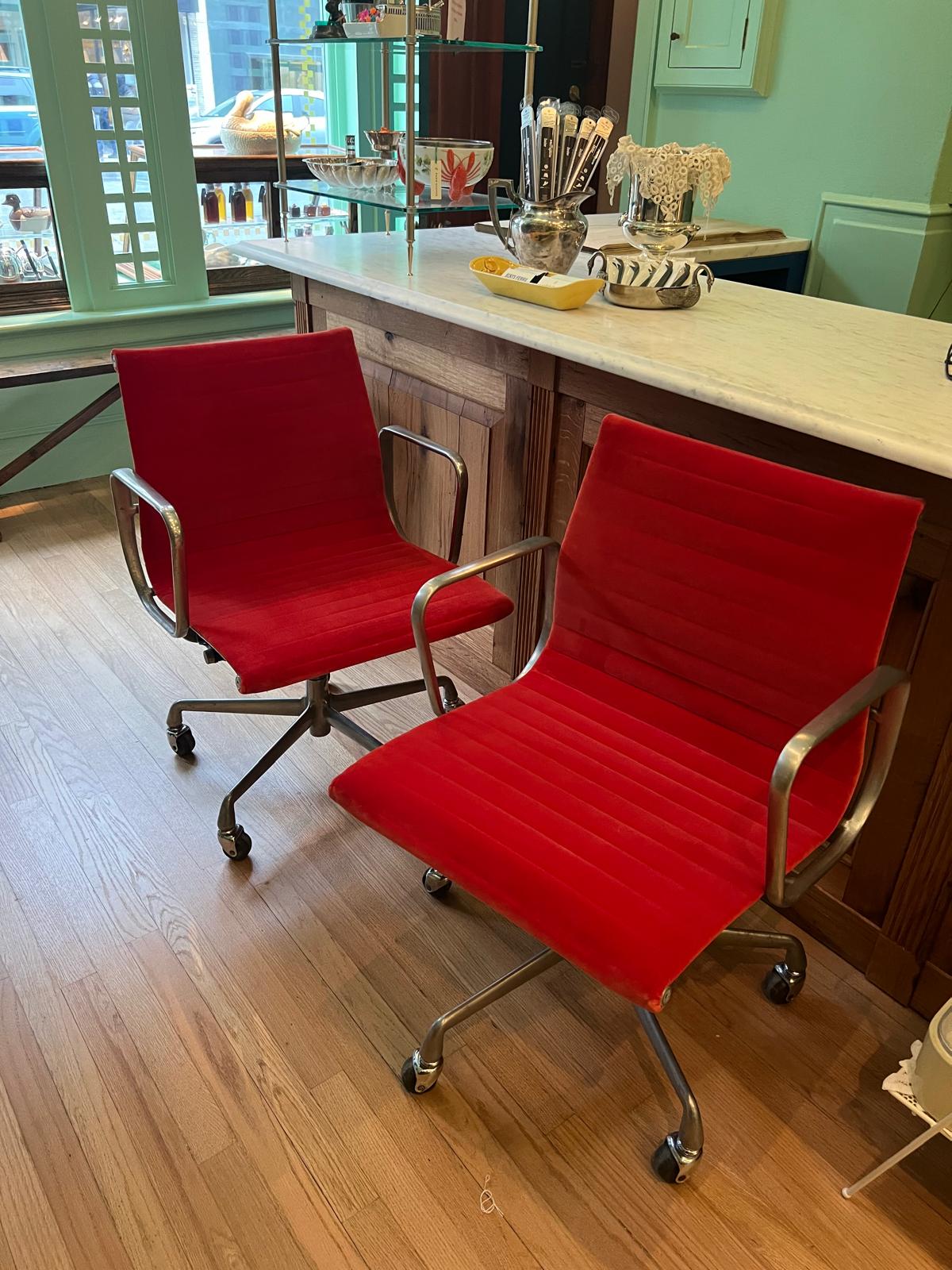Two red office chairs