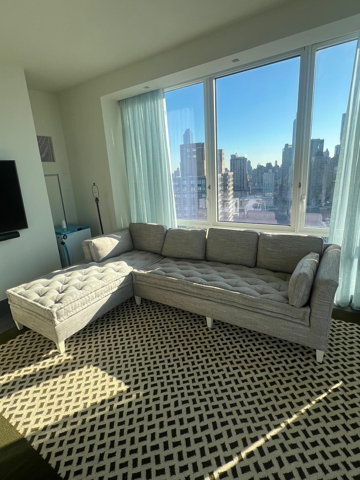 Gray sectional sofa with NYC skyline