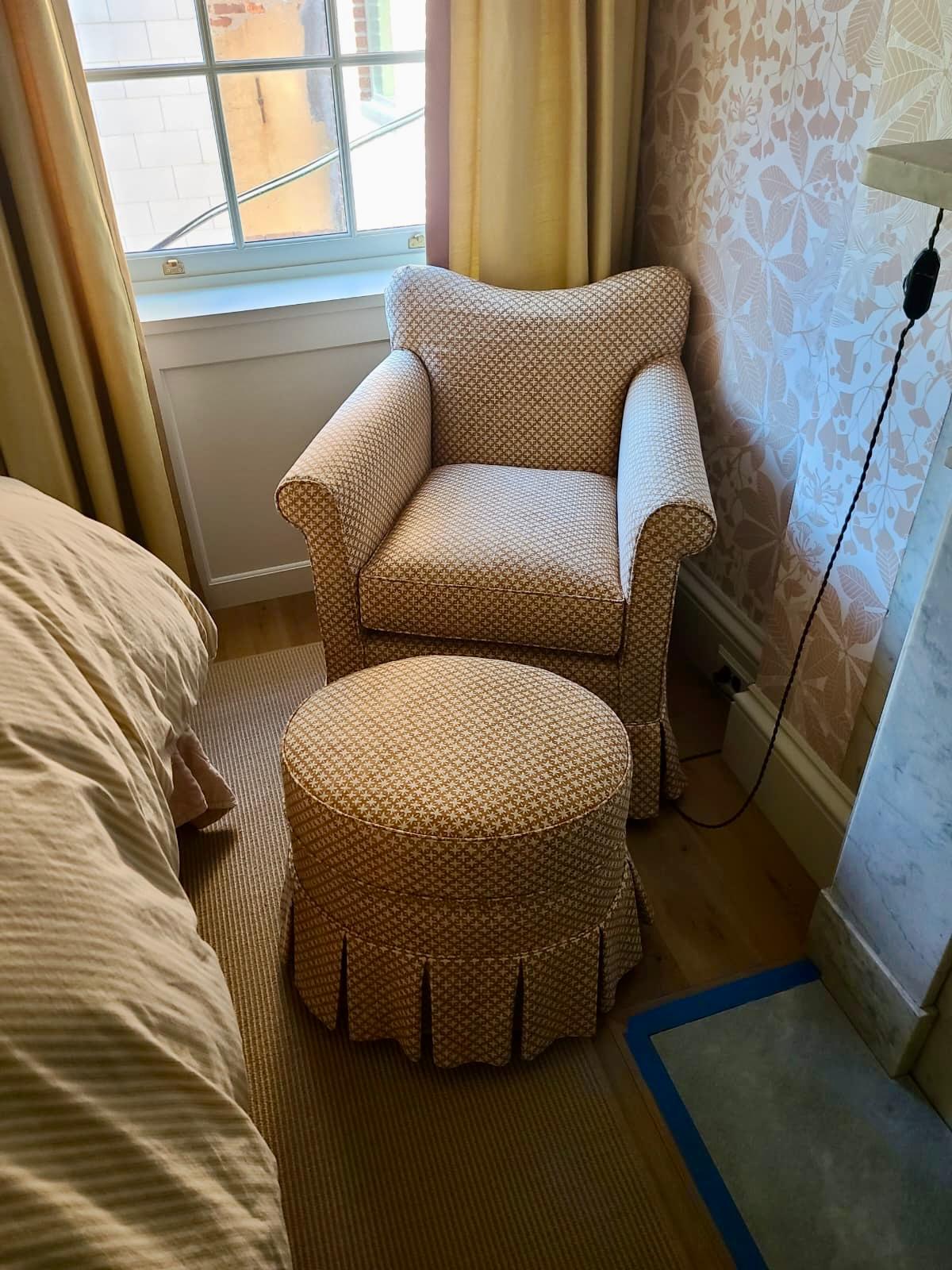Chair and round ottoman in bedroom