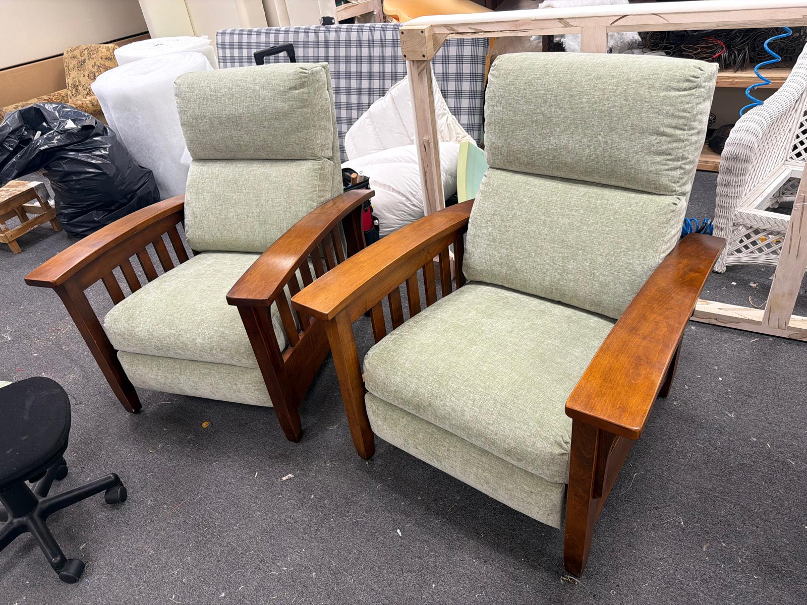 Pair of sage green mission-style chairs in workshop