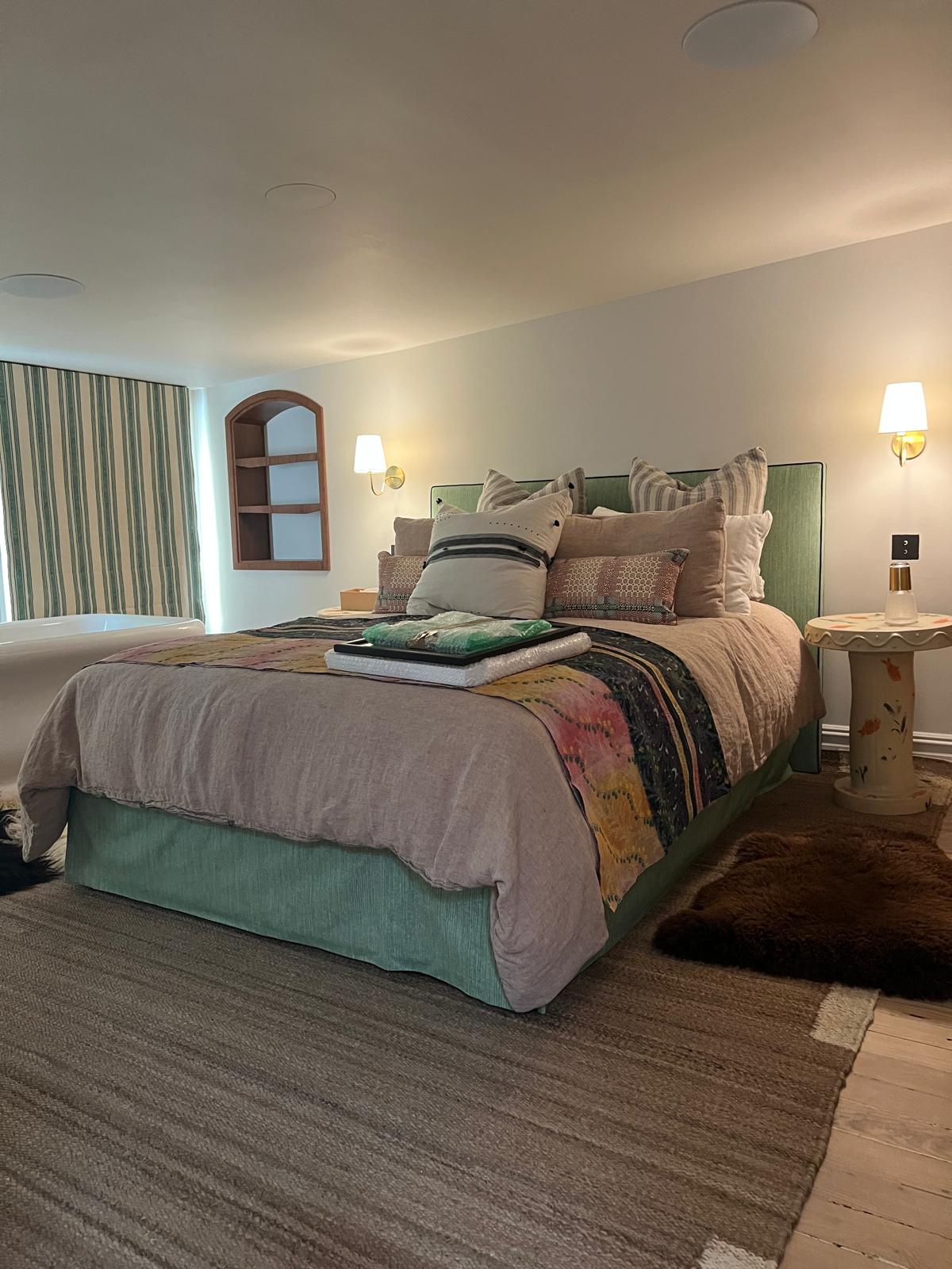 Green striped upholstered headboard in bedroom