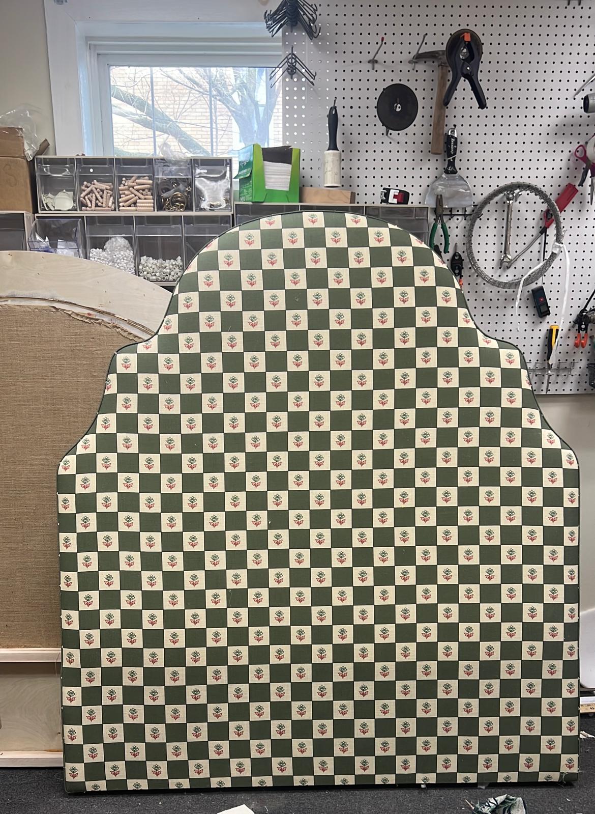 Green checkered upholstered headboard in workshop
