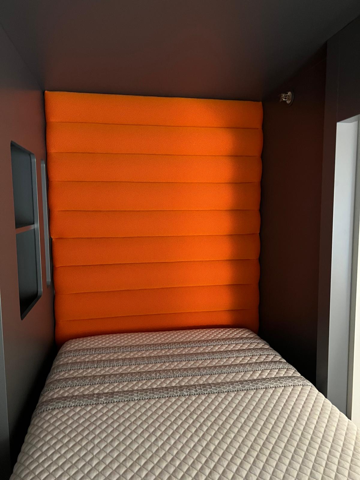 Orange upholstered bunk pod interior