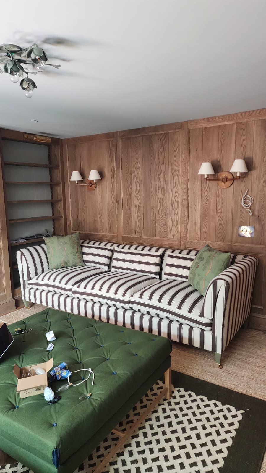 Striped sofa with green tufted ottoman