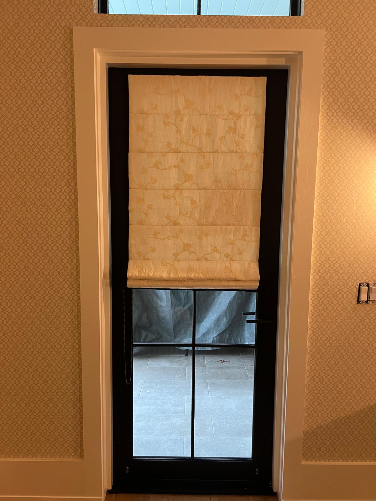 Floral roman shade on French door