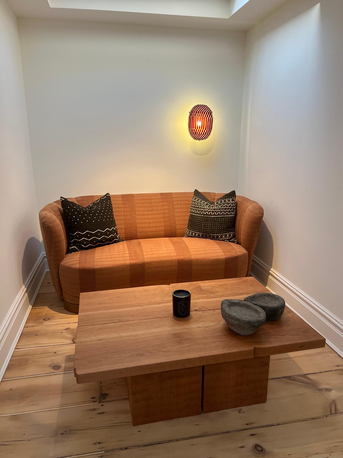 Bold orange curved sofa in nook