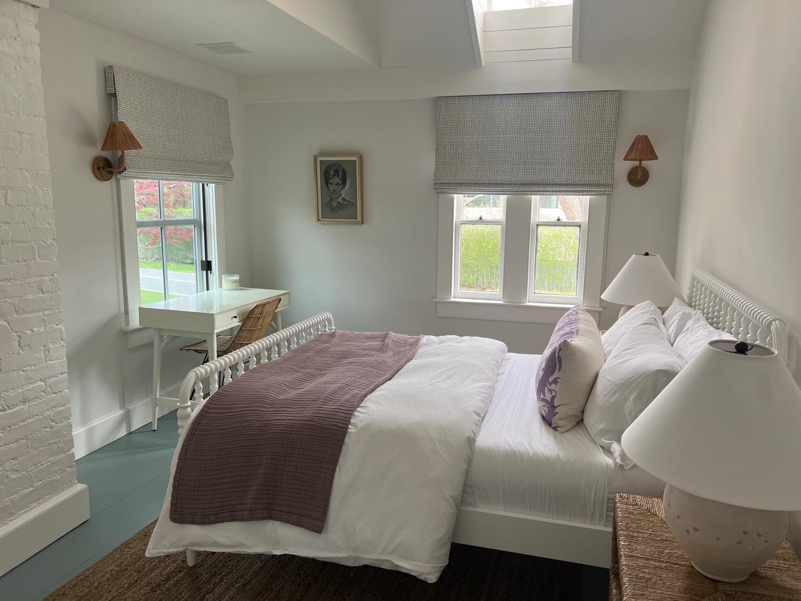 Gray textured roman shades in white bedroom