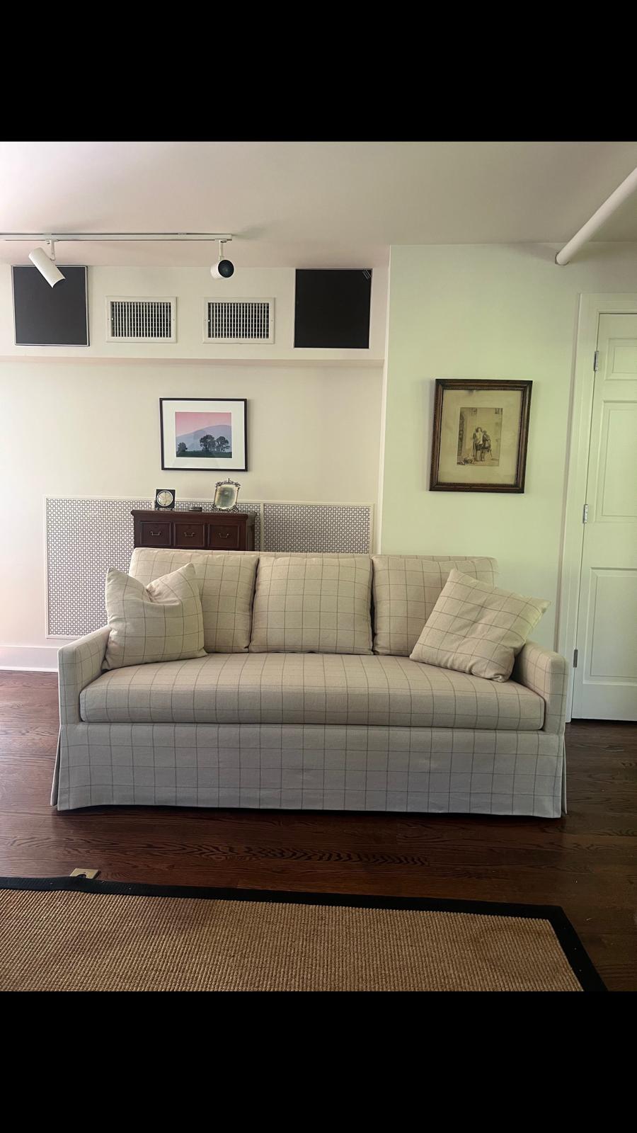 White and gray grid-pattern skirted sofa