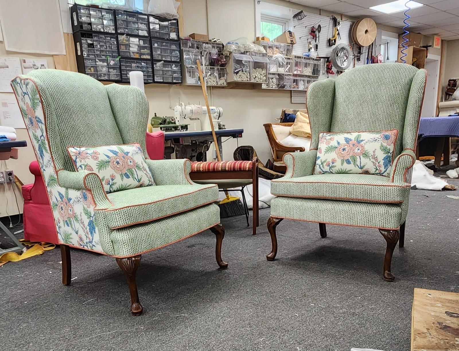 Pair of sage green wingback chairs in workshop