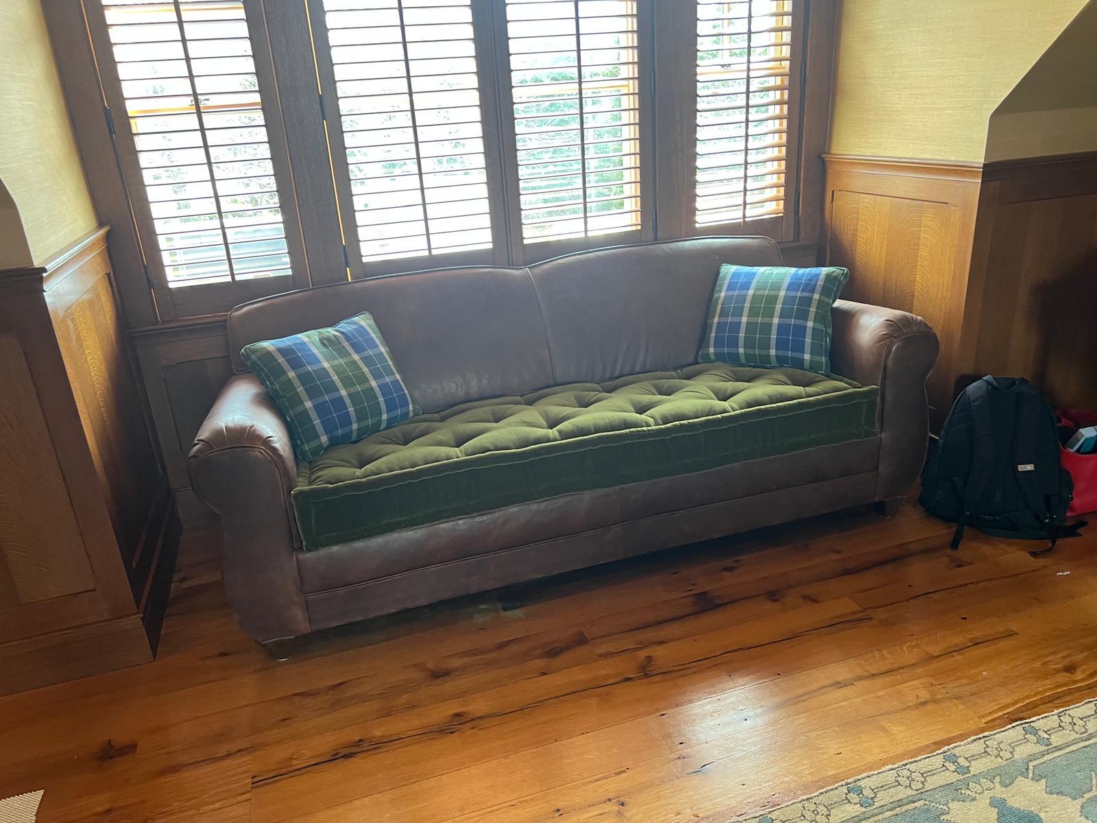 Leather sofa reupholstered with green tufted seat cushion