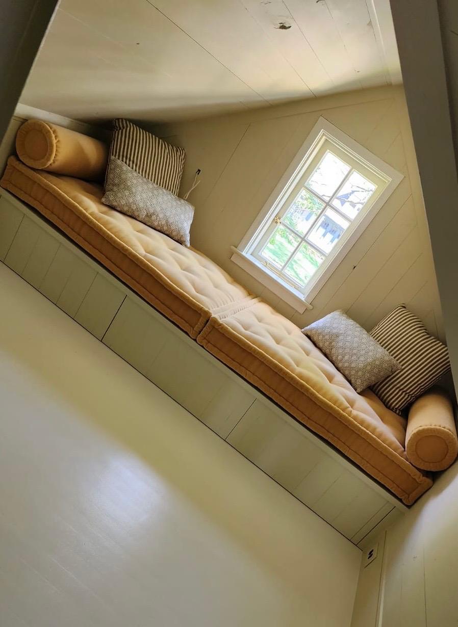 Custom built-in window seat cushions in attic room